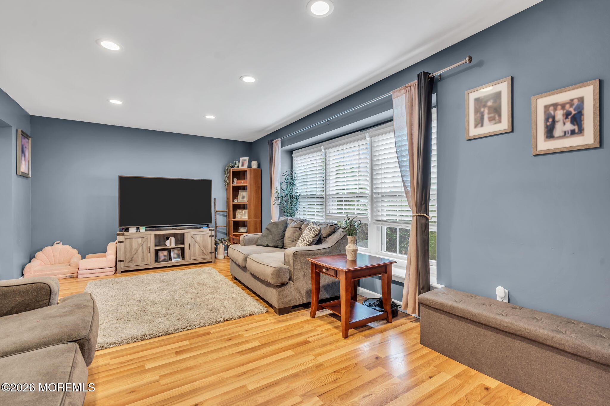 24 Eric Drive Howell, NJ 07731 - Photo 13 of 58 a living room with furniture and a flat screen tv
