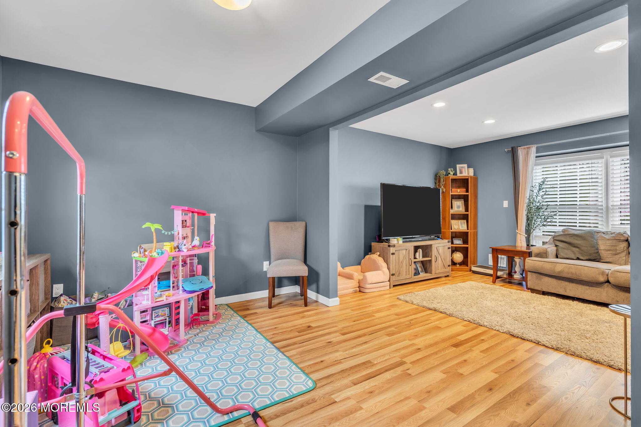 24 Eric Drive Howell, NJ 07731 - Photo 18 of 58 a living room with furniture flat screen tv and windows