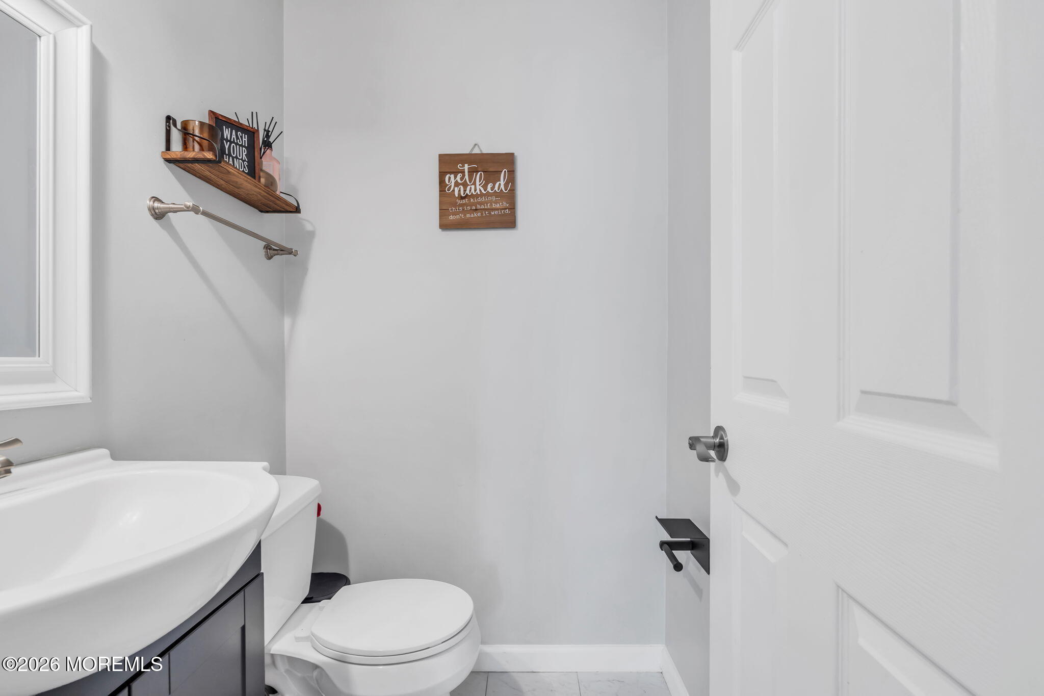 24 Eric Drive Howell, NJ 07731 - Photo 28 of 58 a white toilet sitting next to a white sink
