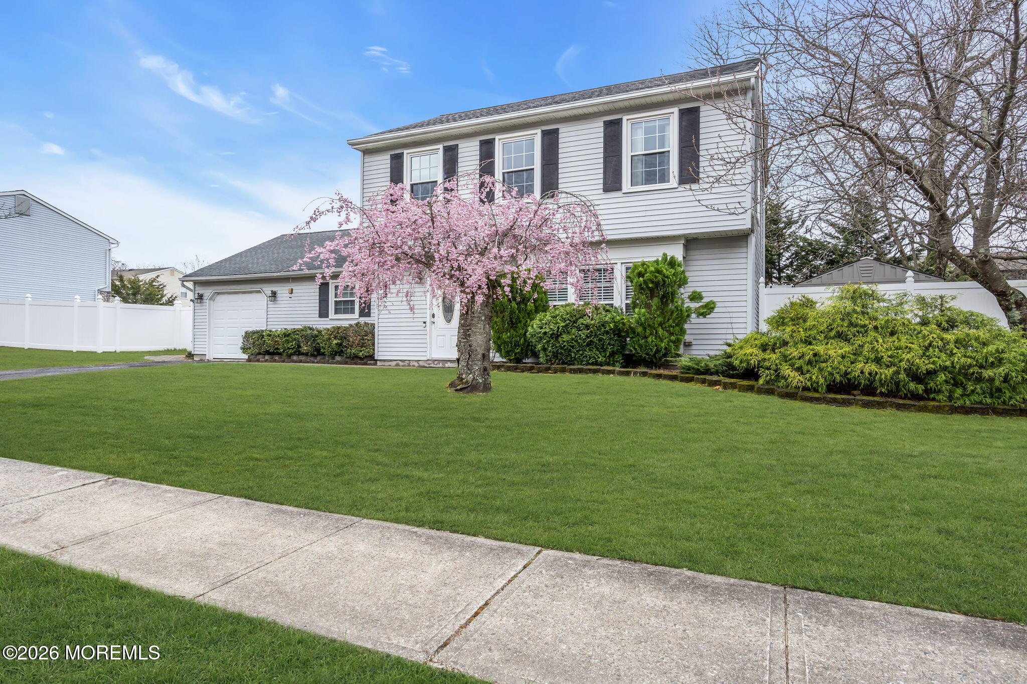 24 Eric Drive Howell, NJ 07731 - Photo 3 of 58 a front view of a house with a garden