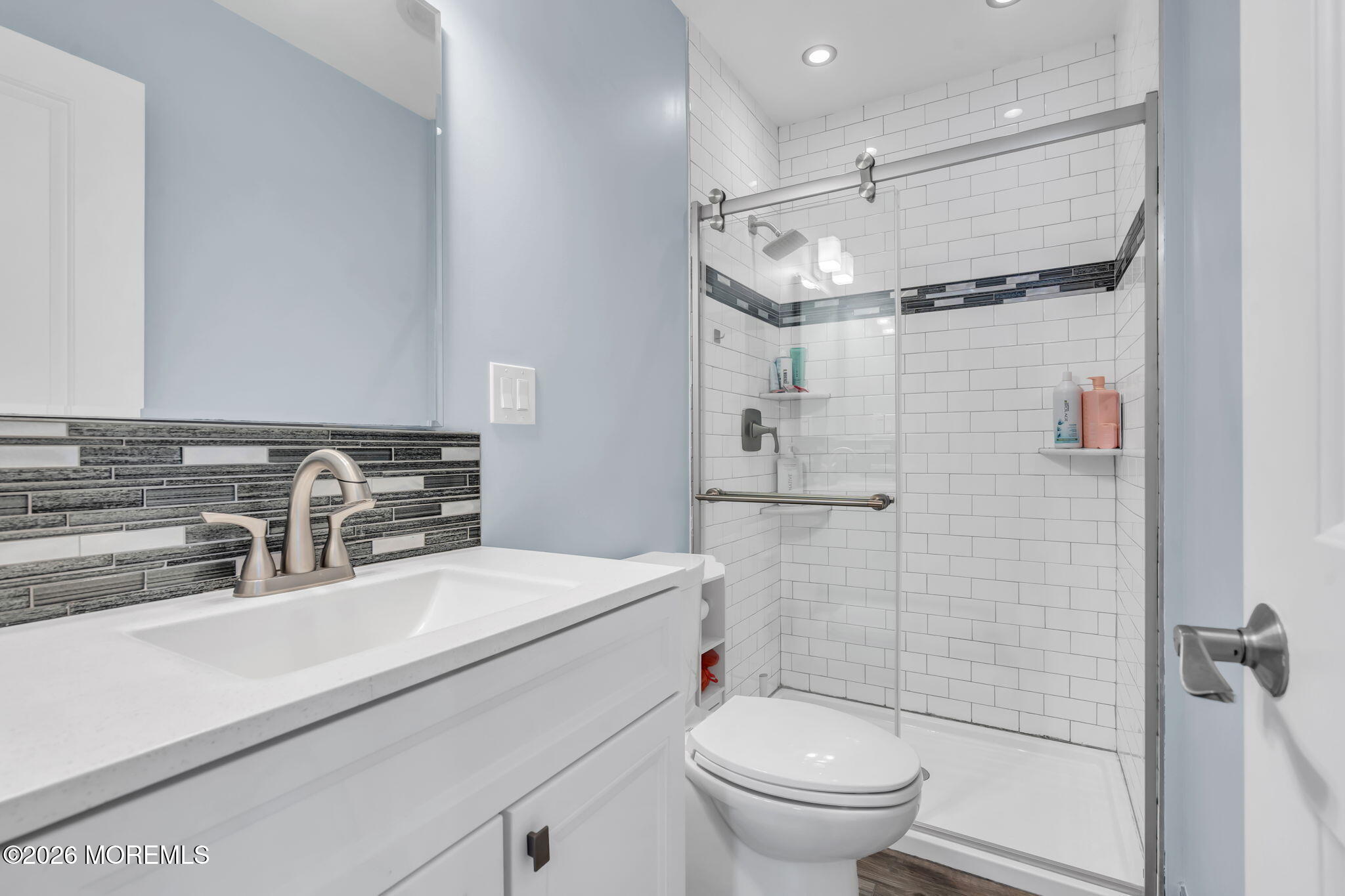 24 Eric Drive Howell, NJ 07731 - Photo 38 of 58 a bathroom with a sink a toilet a mirror and shower