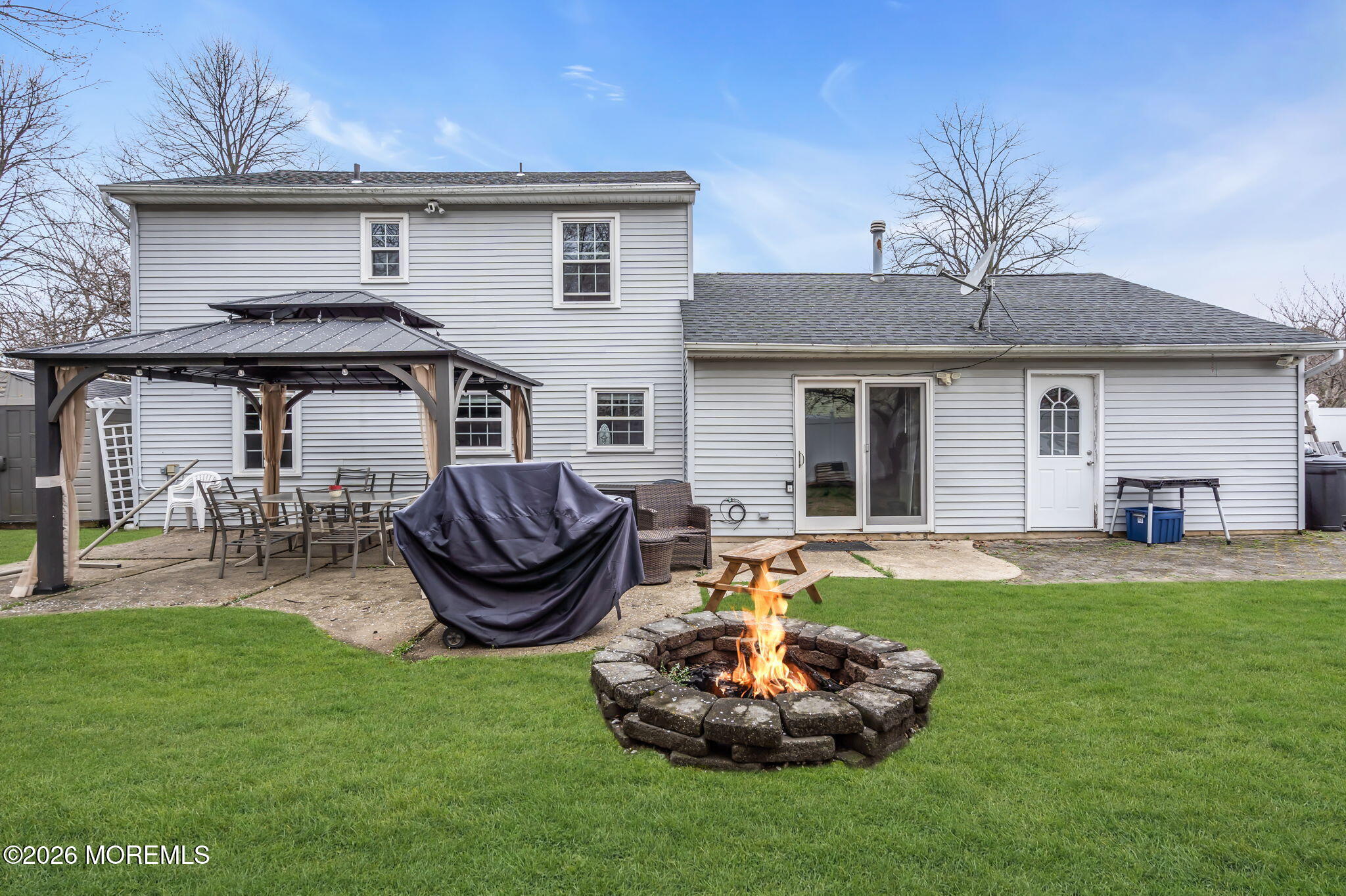 24 Eric Drive Howell, NJ 07731 - Photo 43 of 58 a front view of house with yard and outdoor seating