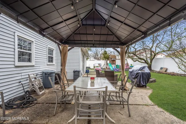 a view of a house with backyard and sitting area