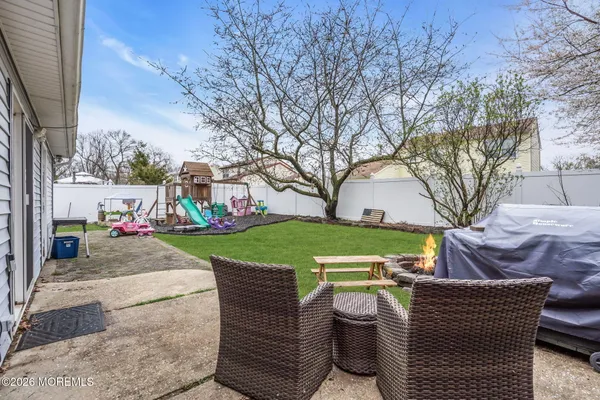 a view of a house with a yard patio and fire pit