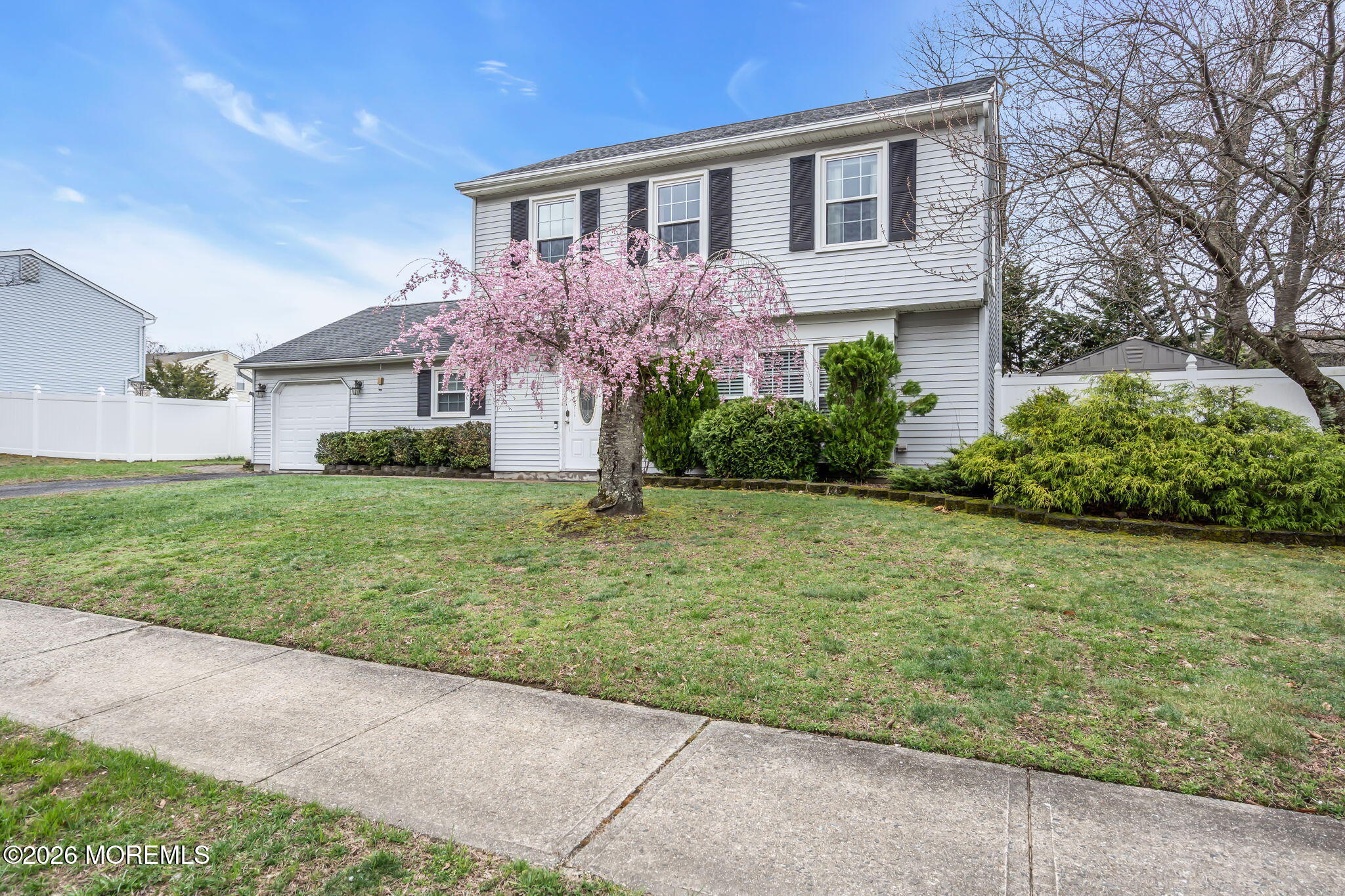 24 Eric Drive Howell, NJ 07731 - Photo 48 of 58 a front view of a house with garden