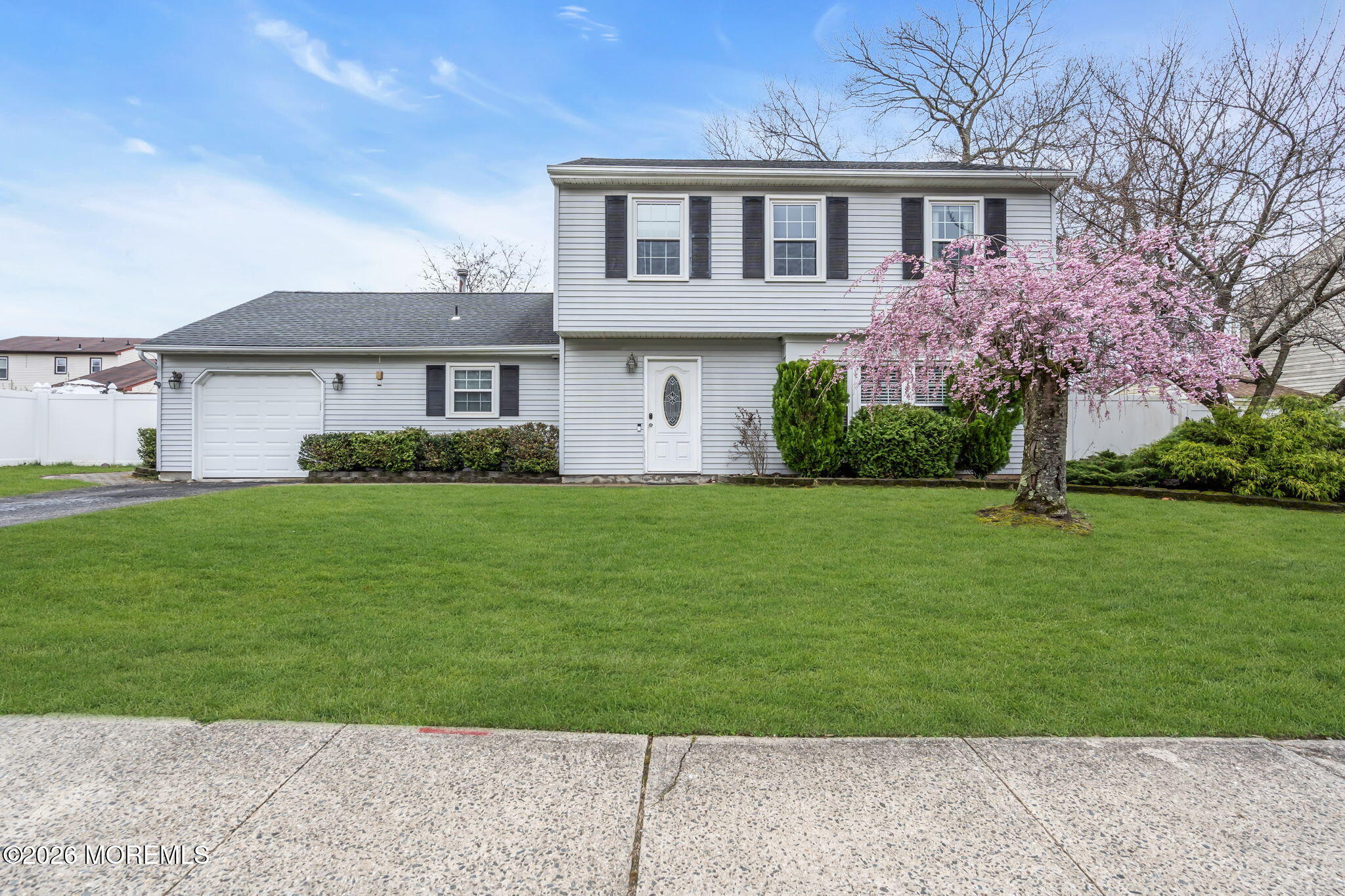 24 Eric Drive Howell, NJ 07731 - Photo 51 of 58 a front view of a house with a garden