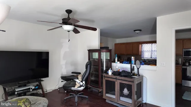 a view of a workspace with furniture and a window