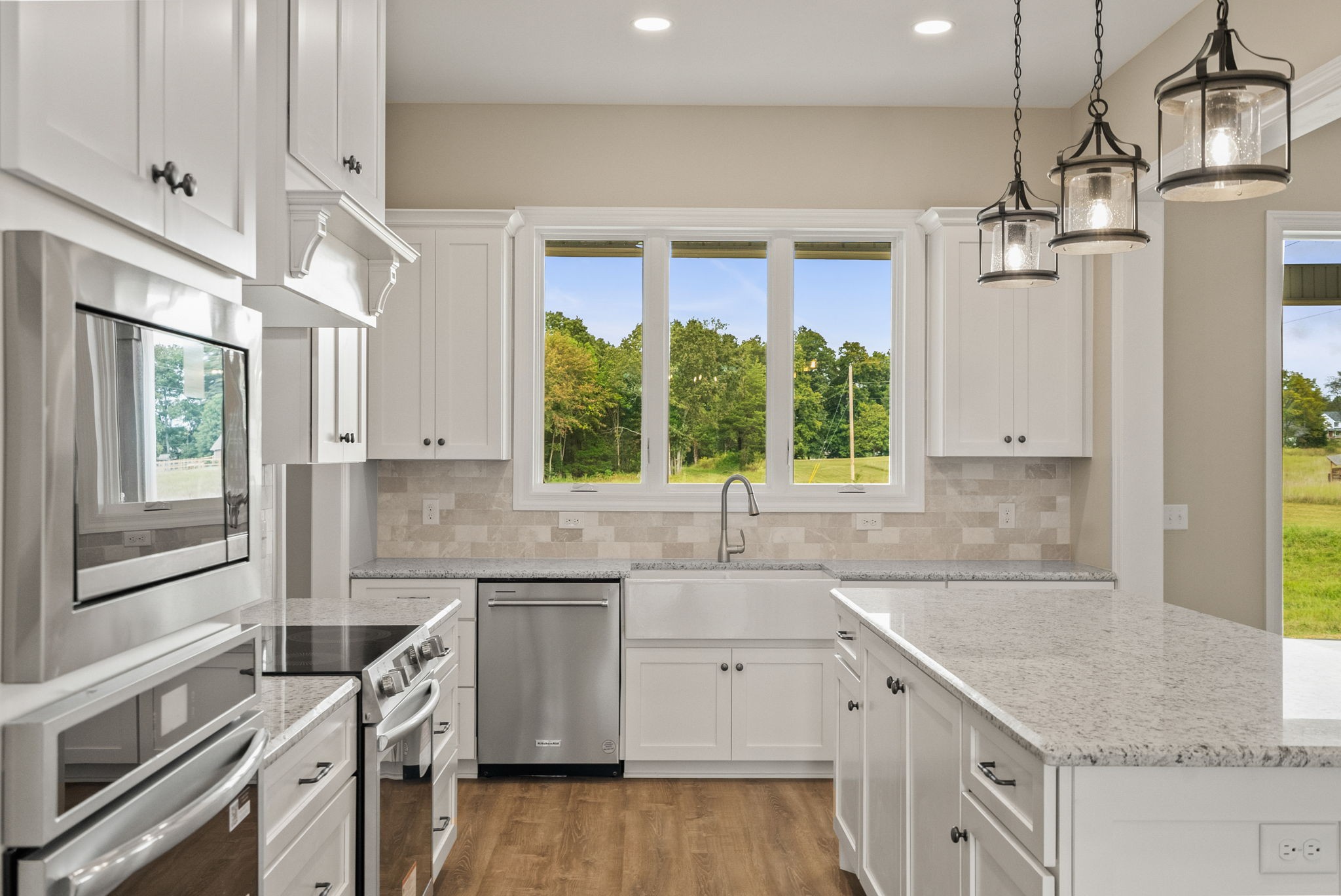 4108 Old Coopertown Road Springfield, TN 37172 - Photo 15 of 39 a kitchen that has a sink a stove and a wooden floor