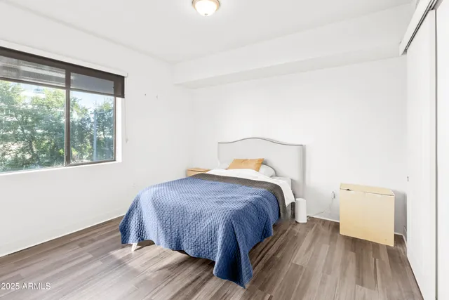 a bedroom with a bed and a window