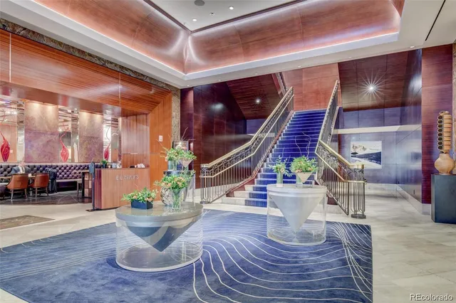 a kitchen with stainless steel appliances granite countertop a refrigerator a stove and a sink