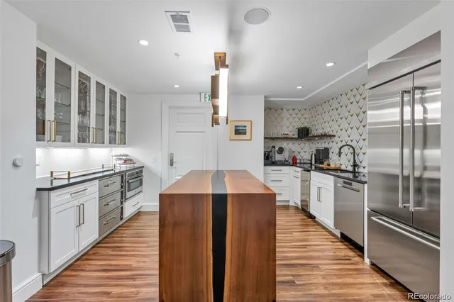 a living room with a couch and a chandelier