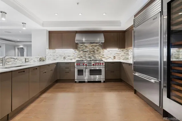 a kitchen with stainless steel appliances a sink and a refrigerator
