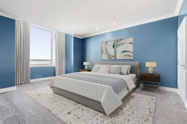 a bedroom with a large bed and a window