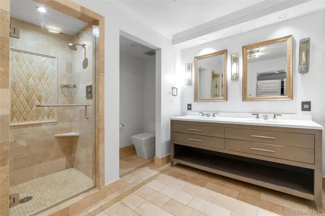 a bathroom with a double vanity sink mirror and shower