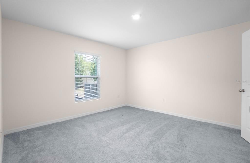 8471 Clearway Drive Wildwood, FL 34785 - Photo 13 of 32 an empty room with a window