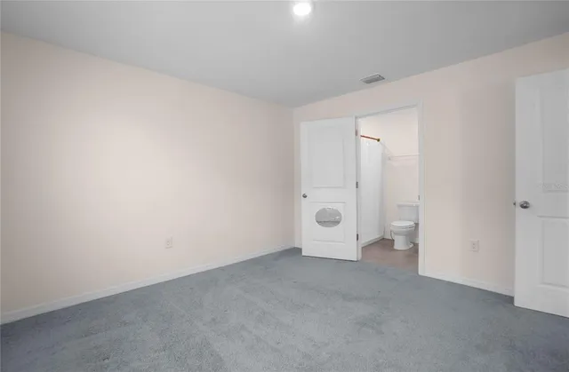 a bathroom with a shower curtain and a toilet
