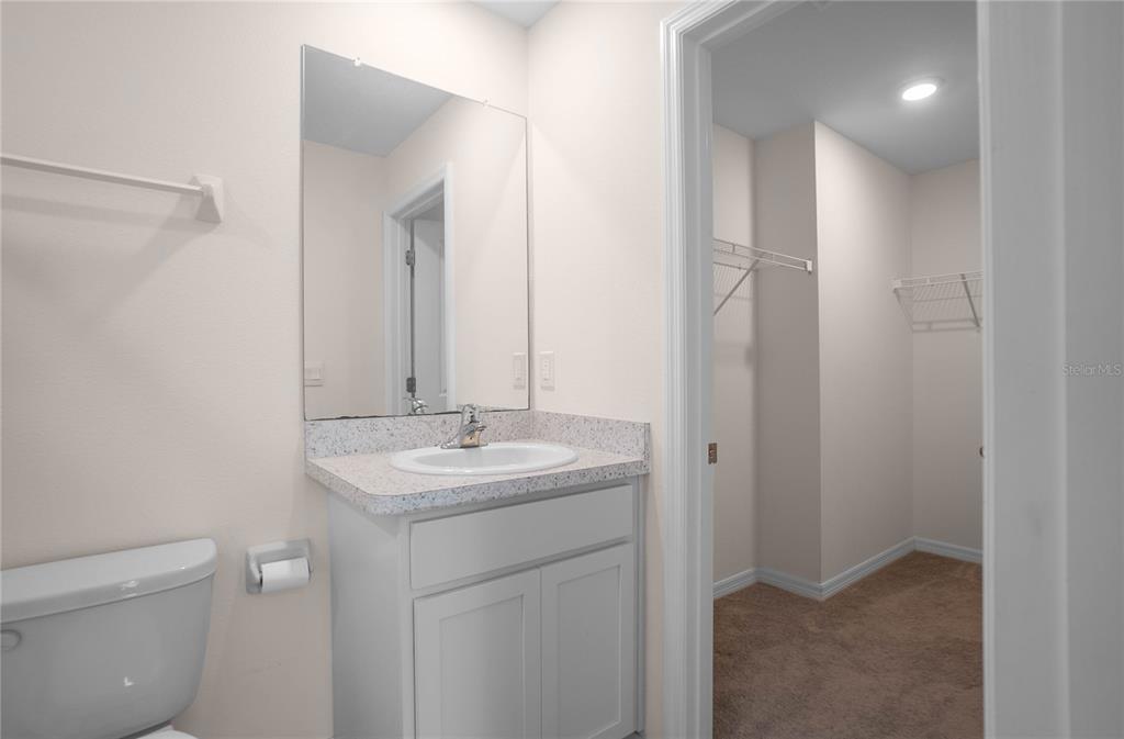 8471 Clearway Drive Wildwood, FL 34785 - Photo 15 of 32 a bathroom with a toilet sink and mirror