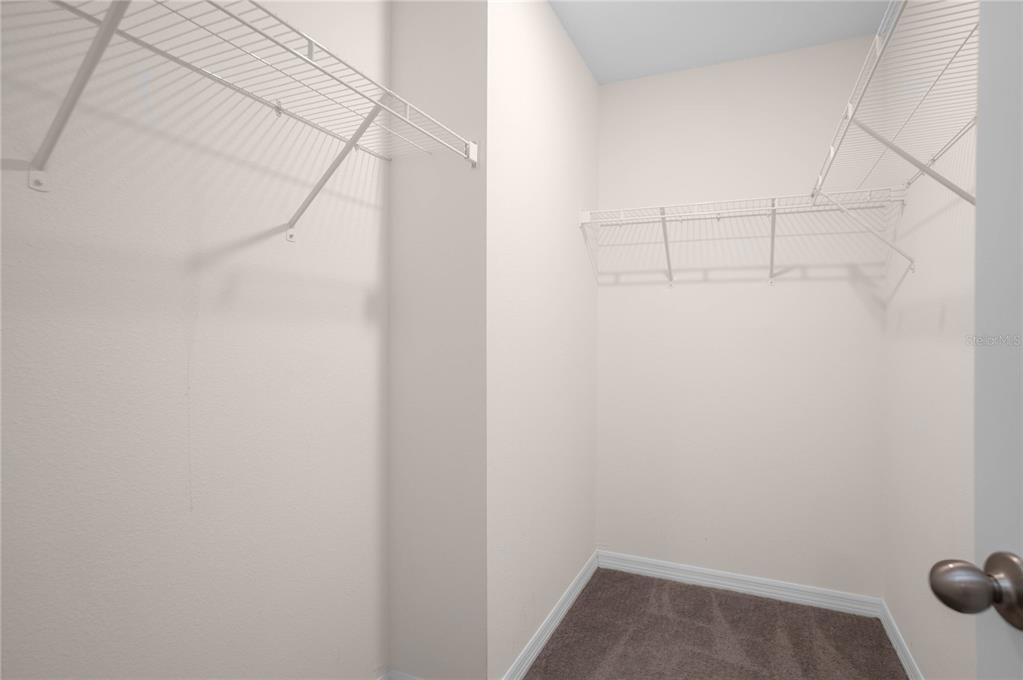 8471 Clearway Drive Wildwood, FL 34785 - Photo 17 of 32 a view of a room with racks on the wall