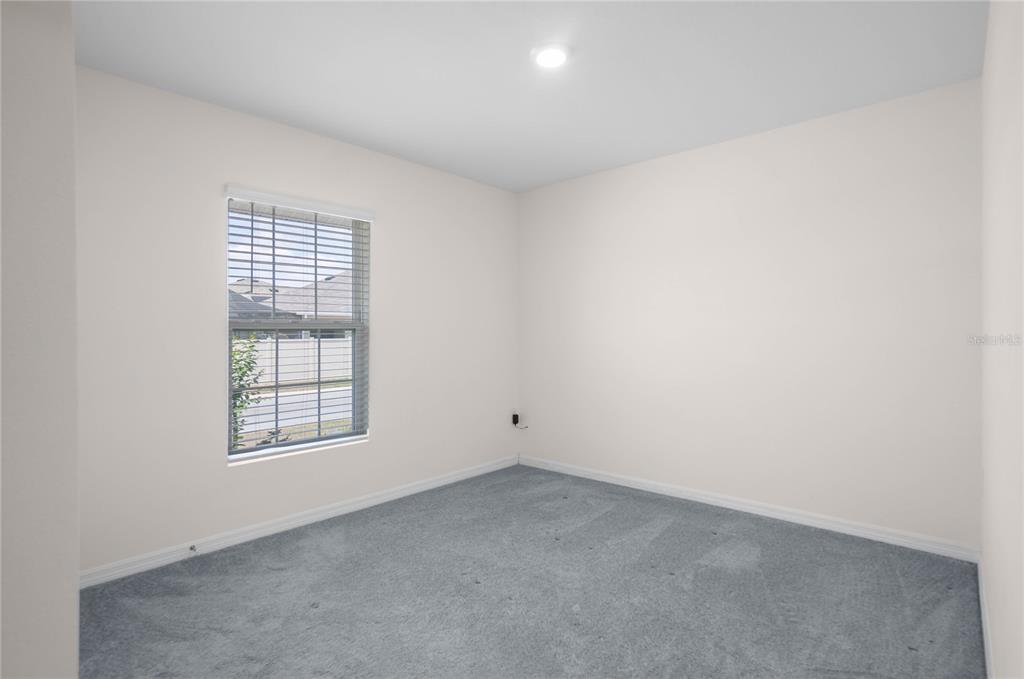 8471 Clearway Drive Wildwood, FL 34785 - Photo 20 of 32 an empty room with windows