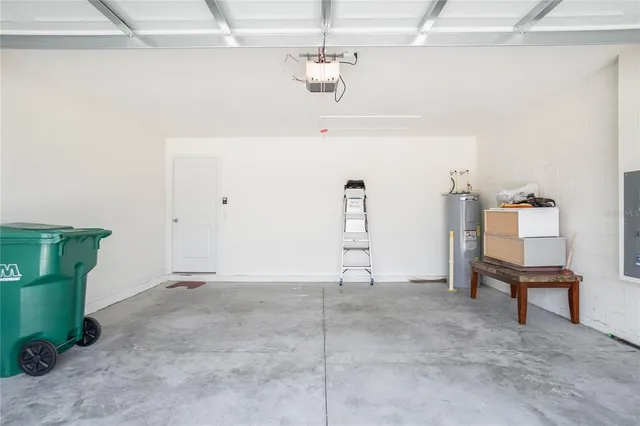 a view of a house with backyard and trees