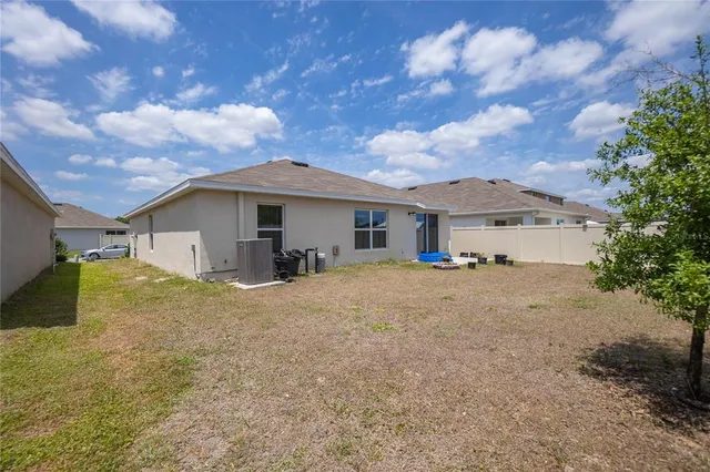 an aerial view of a house with a swimming pool outdoor seating and yard