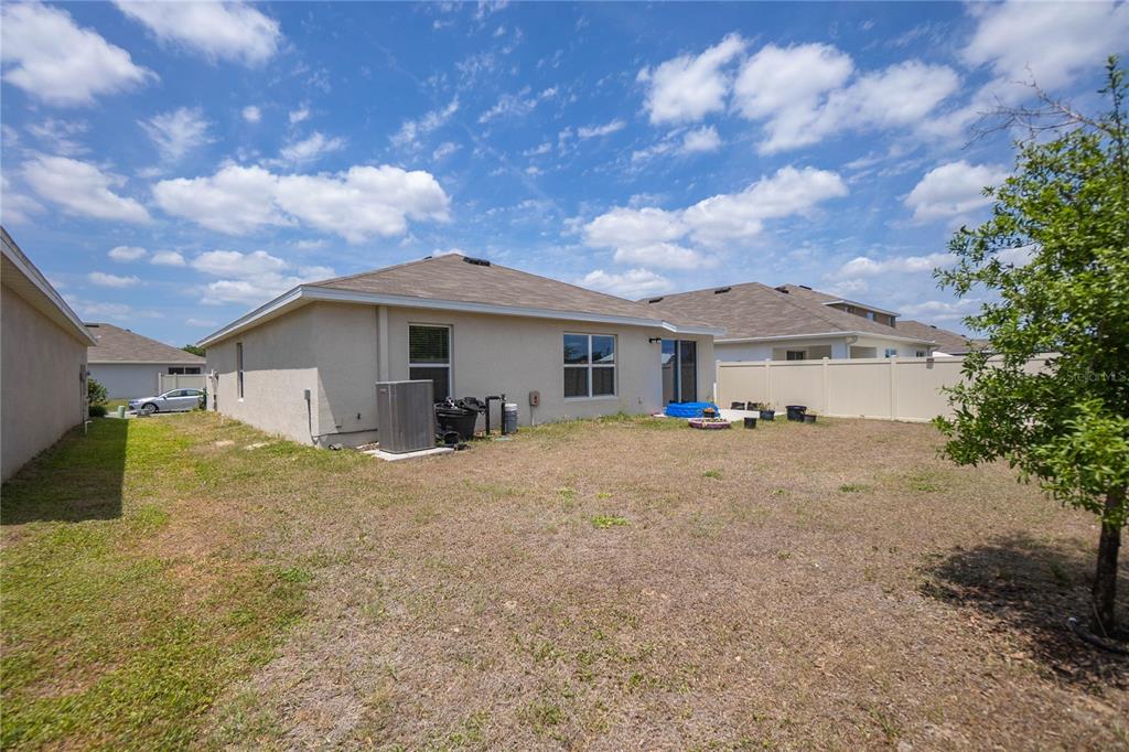 8471 Clearway Drive Wildwood, FL 34785 - Photo 25 of 32 a view of a house with backyard and trees