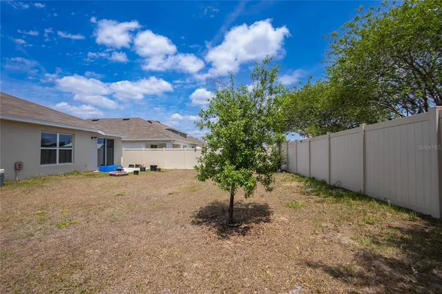 an aerial view of multiple houses with yard
