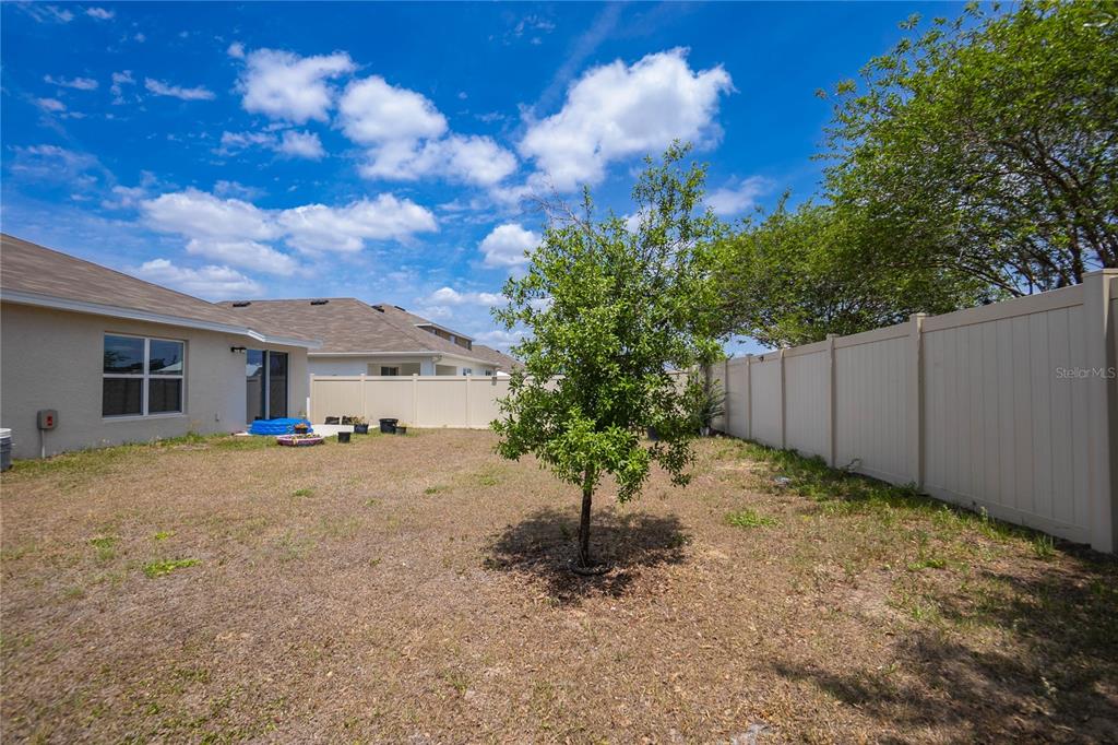 8471 Clearway Drive Wildwood, FL 34785 - Photo 26 of 32 a view of a house with porch and garden