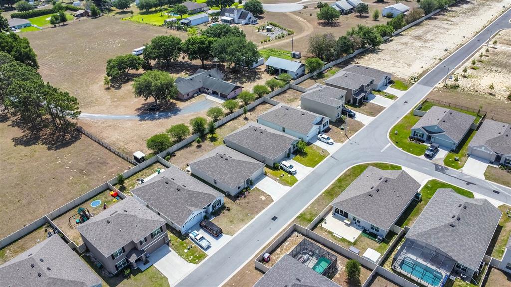 8471 Clearway Drive Wildwood, FL 34785 - Photo 31 of 32 an aerial view of a house with a garden