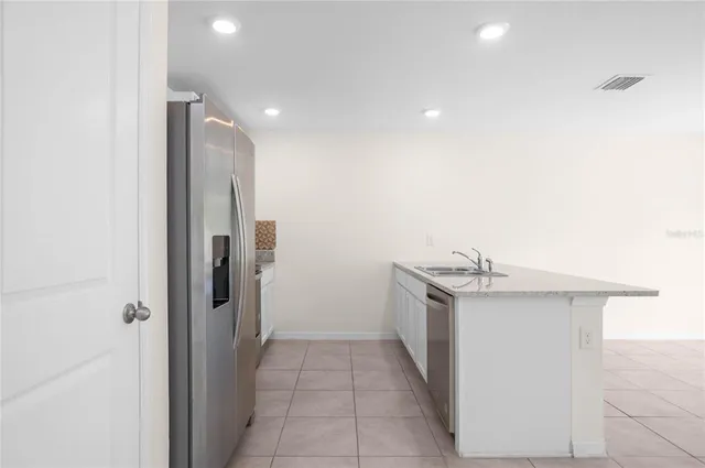 a kitchen with cabinets stainless steel appliances and a counter space