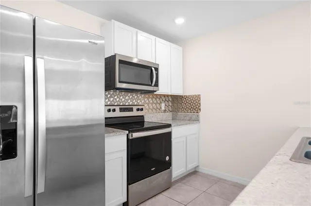 a kitchen with kitchen island a sink stainless steel appliances and counter space