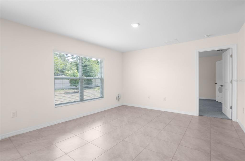 8471 Clearway Drive Wildwood, FL 34785 - Photo 9 of 32 an empty room with windows and closet
