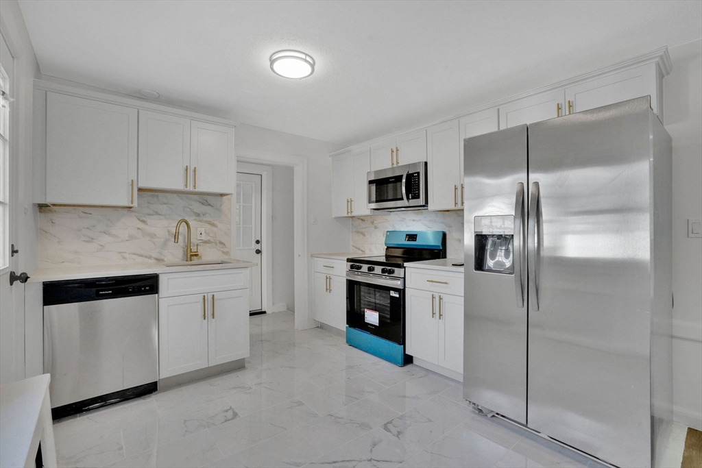 100 Abbott Street Springfield, MA 01118 - Photo 15 of 31 a kitchen with granite countertop a refrigerator stove and sink