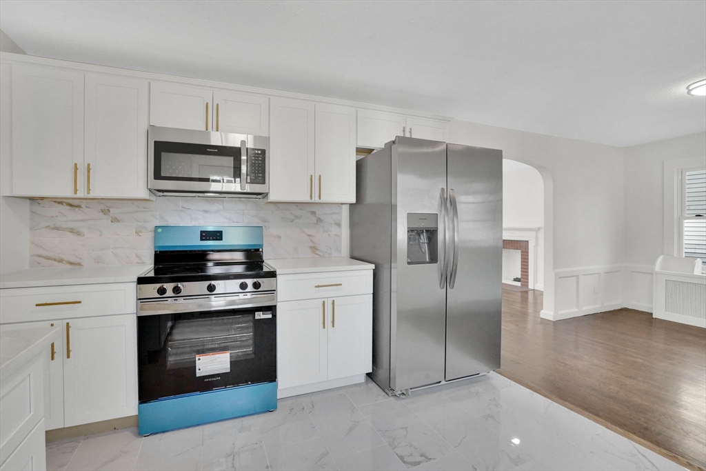 100 Abbott Street Springfield, MA 01118 - Photo 16 of 31 a kitchen with stainless steel appliances granite countertop a refrigerator stove and sink