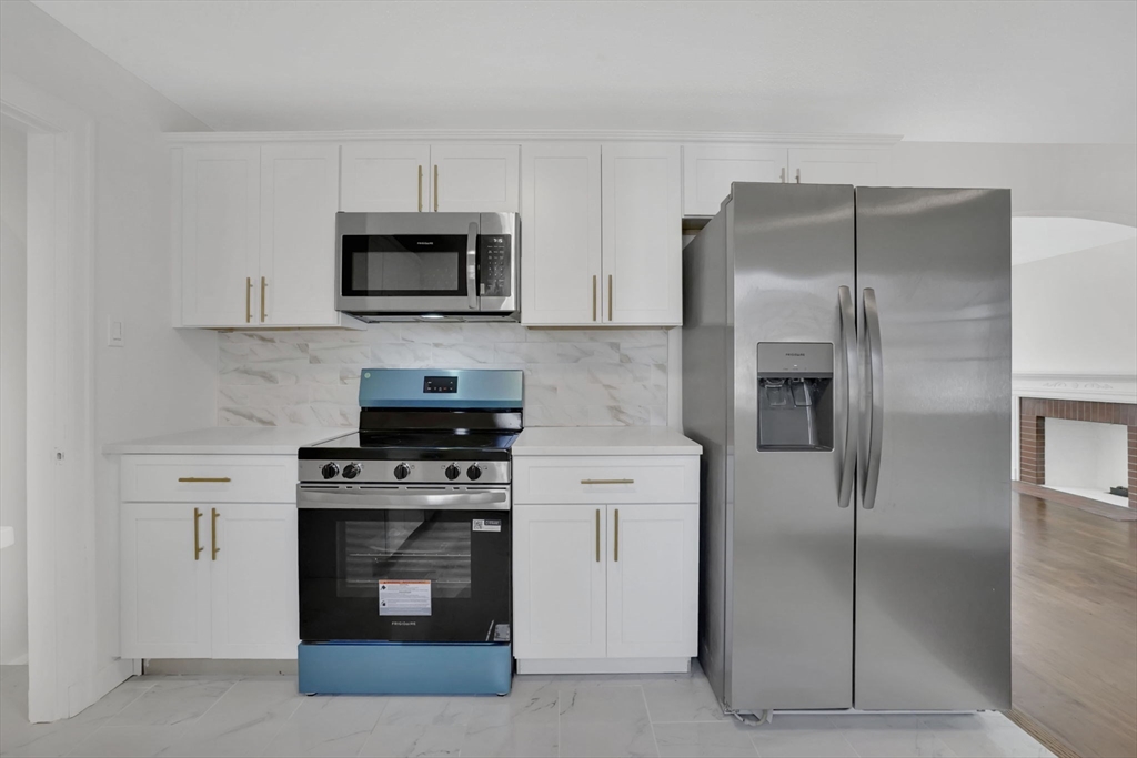 100 Abbott Street Springfield, MA 01118 - Photo 17 of 31 a kitchen with stainless steel appliances granite countertop a stove and a refrigerator