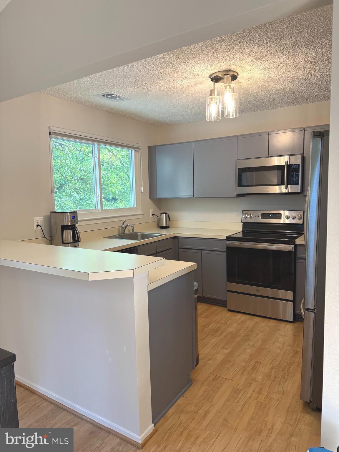 11743 Summerchase Circle, Unit B Reston, VA 20194 - Photo 4 of 25 a kitchen with a stove and a sink