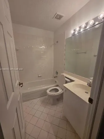 an empty room with wooden floor and closet