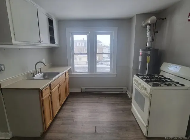 a kitchen with a sink stove and cabinets