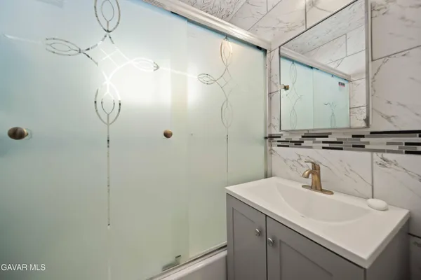 a bathroom with a sink and mirror