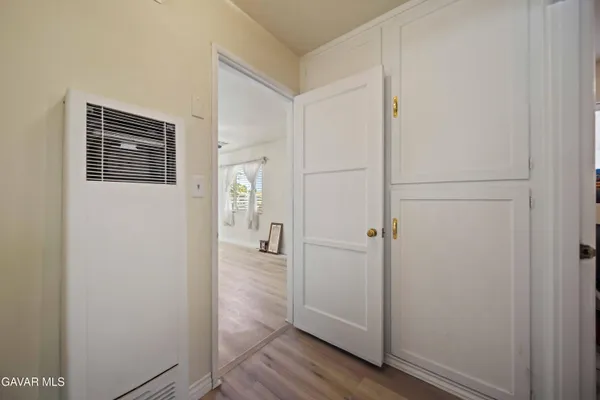 a view of a hallway with wooden floor