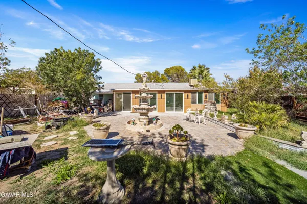 a view of a house with swimming pool and sitting area