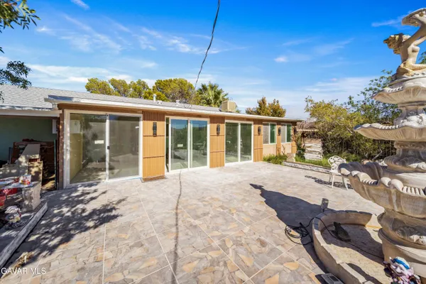a view of a house with backyard and porch