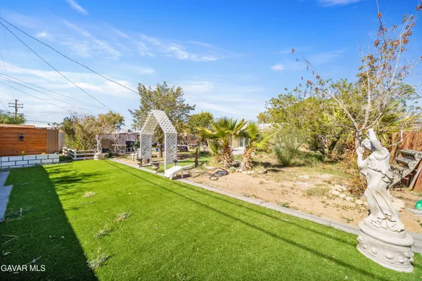 a view of yard with swimming pool and green space
