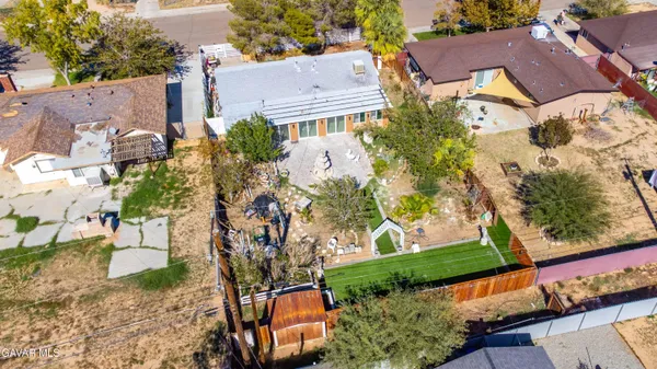 an aerial view of multiple houses with yard