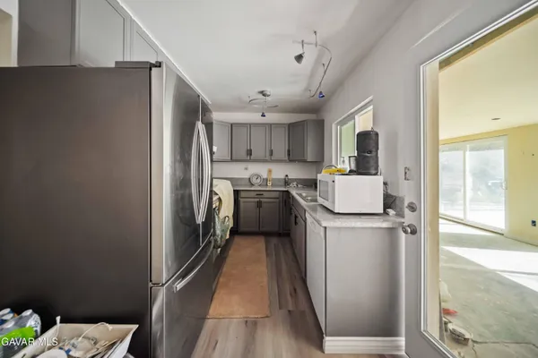 a kitchen with refrigerator a washer and dryer