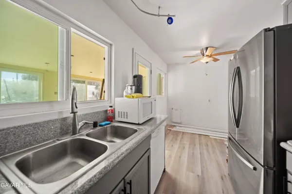 a kitchen with a sink and refrigerator