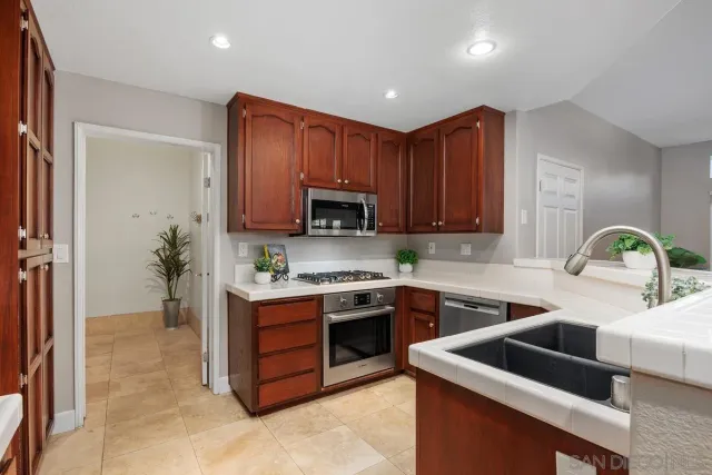 a kitchen that has a sink and a stove in it