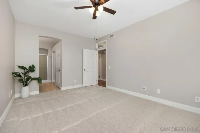 a view of an empty room and a window