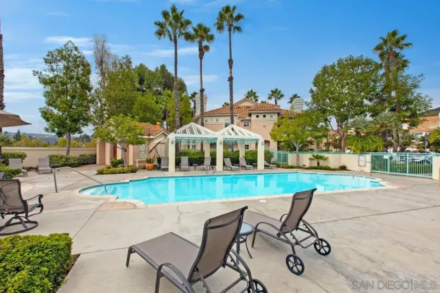 a front view of multiple house with yard and lake view
