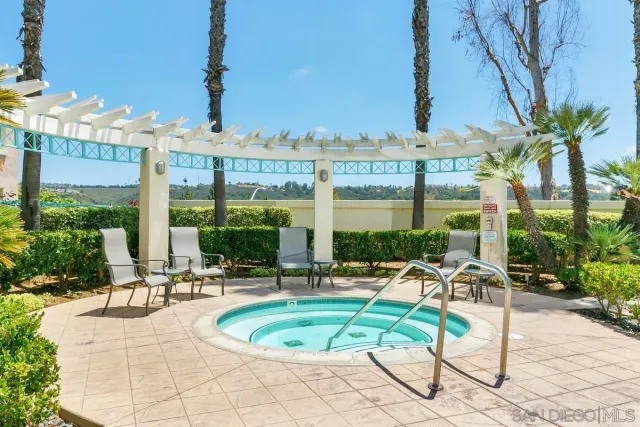 a view of a house with a yard and potted plants